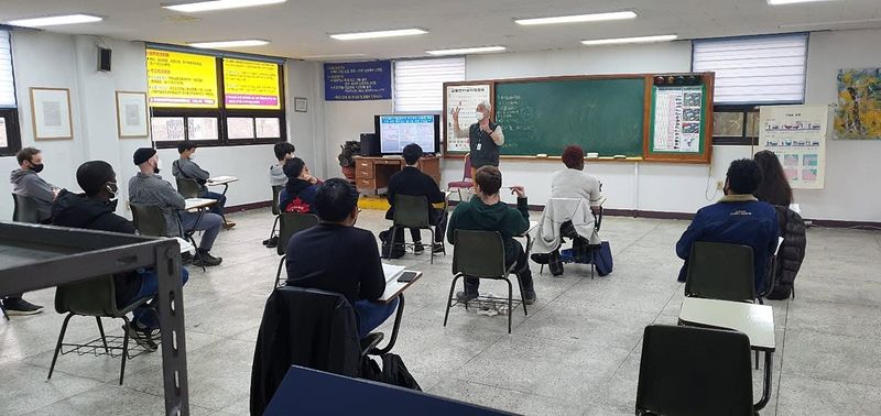Foreign student holding a newly issued Korean driver's licence at Anyang Driving School