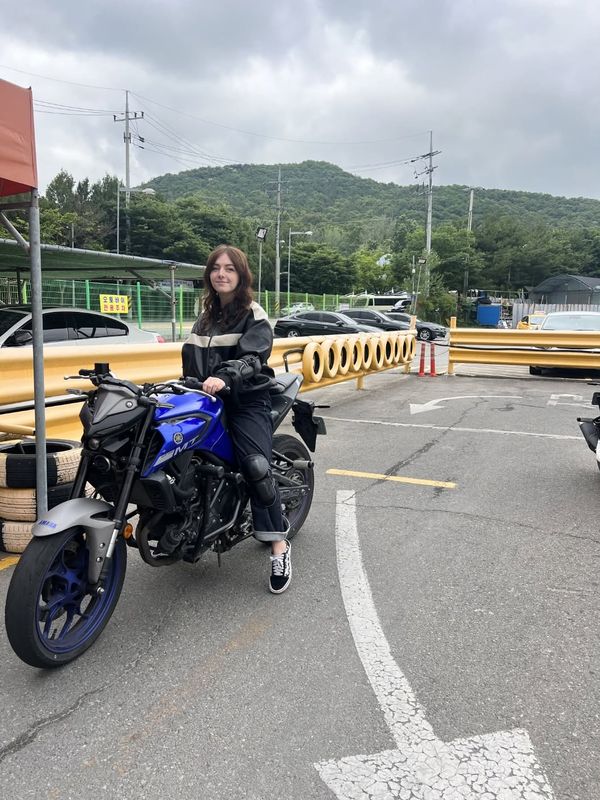 Foreign student holding a newly issued Korean driver's licence at Anyang Driving School
