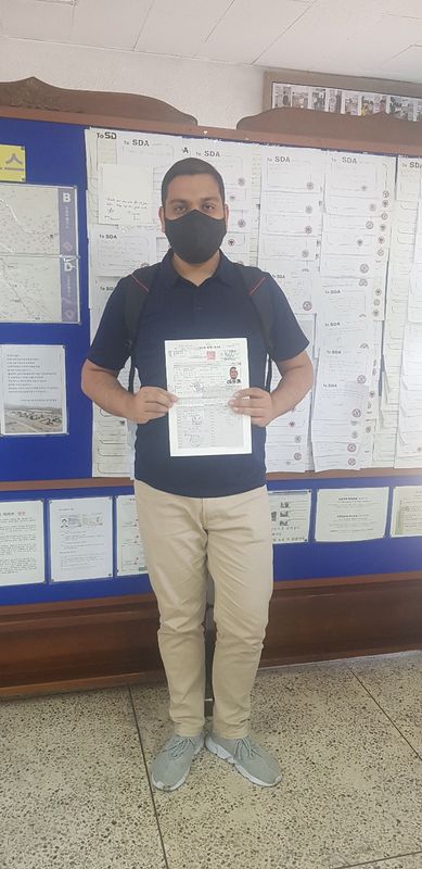 Foreign student holding a newly issued Korean driver's licence at Anyang Driving School