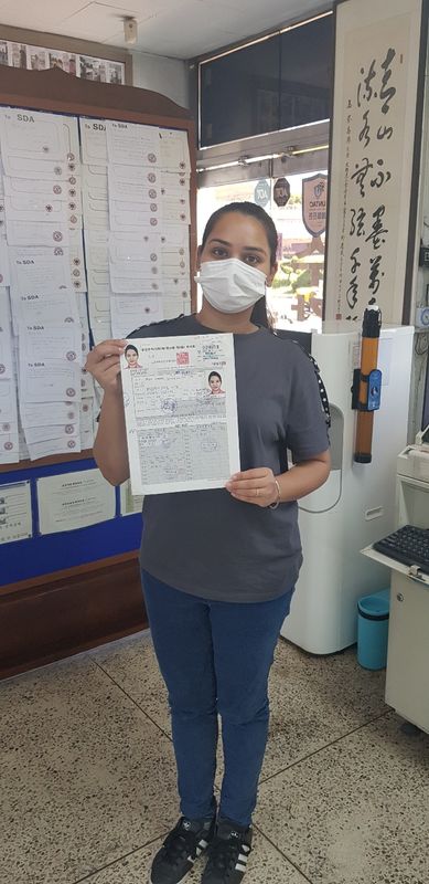International student celebrating a road driving test pass at Anyang Driving School