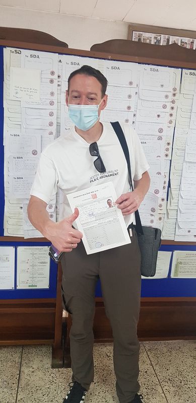 Foreign student holding a newly issued Korean driver's licence at Anyang Driving School