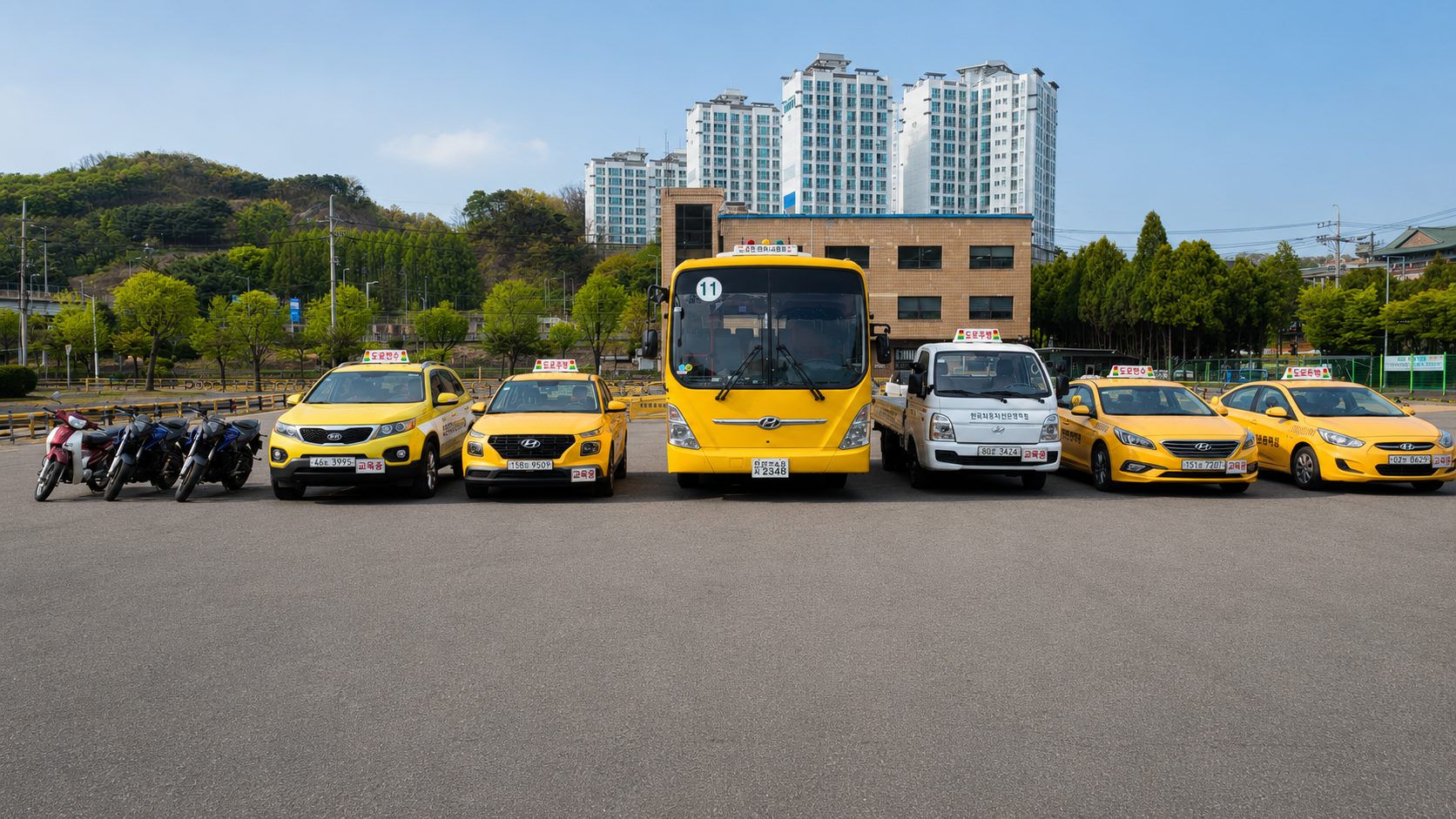Car, bus and motorcycle training vehicles lined up at Anyang Driving School